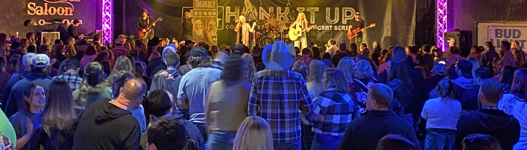 country concert with fans wearing cowboy hats New Orleans